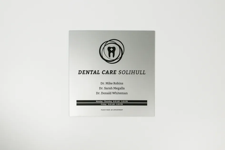 laser engraved dental office sign created with trotec co laser cutter on silver metal plate